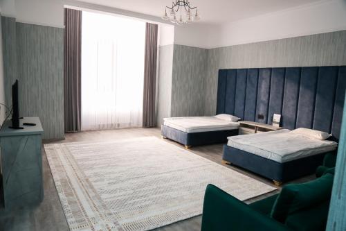 sypialnia z 2 łóżkami i kanapą w obiekcie Hotel Inju w mieście Borowoje