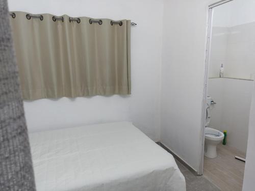 a bedroom with a bed and a shower curtain at הבית של יעל in Tel Aviv