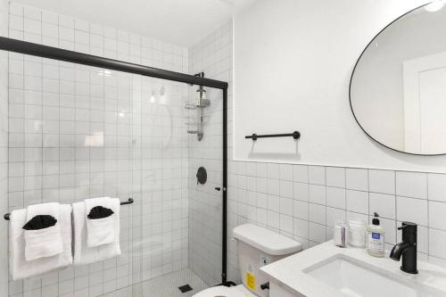 a bathroom with a toilet and a sink and a mirror at Paokalani Studio suite.hōʻoluʻolu in Chandler