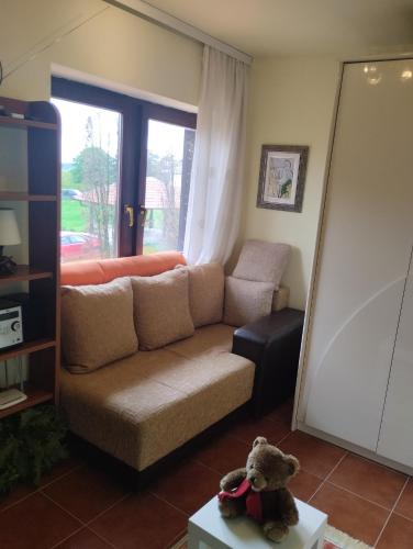 a teddy bear sitting on a table in a living room at Dečiji vinogradi Belgrade, Sopot, Kosmaj in Sopot