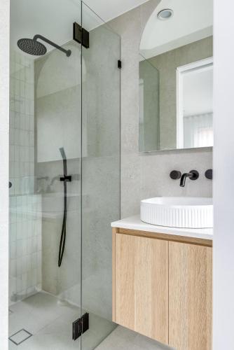 a bathroom with a shower and a sink at Kahlo Bondi - Luxury Escape - 1 Bedroom Furnished Apartments #4 in Sydney