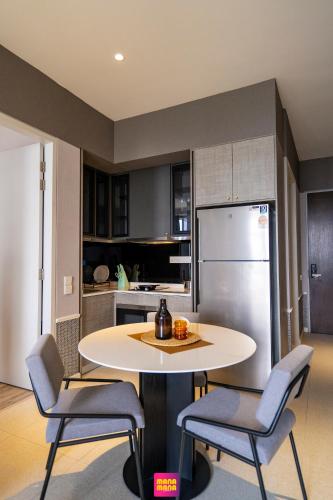 a kitchen with a table and chairs and a refrigerator at Millerz Square Mana-Mana Suite in Kuala Lumpur