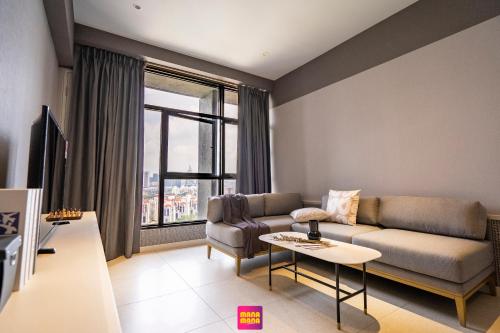 a living room with a couch and a table at Millerz Square Mana-Mana Suite in Kuala Lumpur