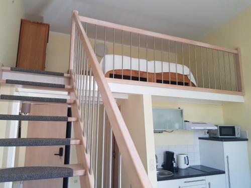 a staircase leading up to a bunk bed in a room at B-Haus Ueckermünde in Ueckermünde