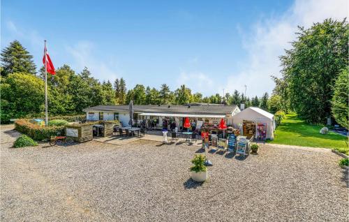 a house with a flag and a patio at Stunning Home In Fårvang With Wifi in Fårvang