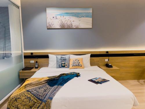 a bedroom with a large bed with white sheets and pillows at Mango Hotel - Ha Noi Railway station in Hanoi