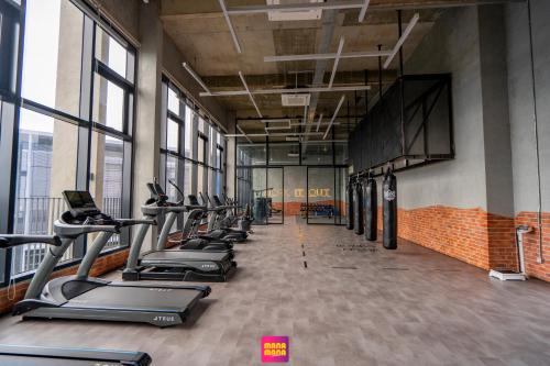 a row of treadmills in a gym with windows at Millerz Square Mana-Mana Suite in Kuala Lumpur