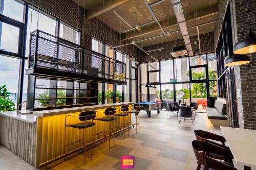 a restaurant with a bar with chairs and tables at Millerz Square Mana-Mana Suite in Kuala Lumpur