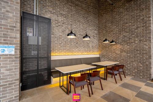 a restaurant with tables and chairs in a brick wall at Millerz Square Mana-Mana Suite in Kuala Lumpur