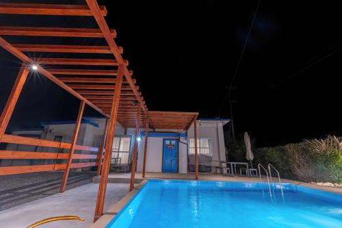 a swimming pool at night with a house at private house noko in Miyako Island