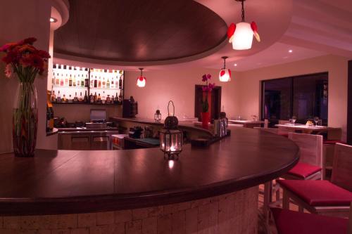 a bar with a large wooden counter in a restaurant at Bidwood Suite Hotel in Nairobi