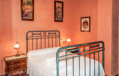 a bedroom with a bed and a table with a night stand at Alojamiento Rural El Chico in Arenas del Rey