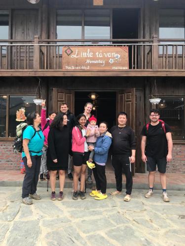 a group of people standing in front of a building at Little Ta Van Homestay in Sapa