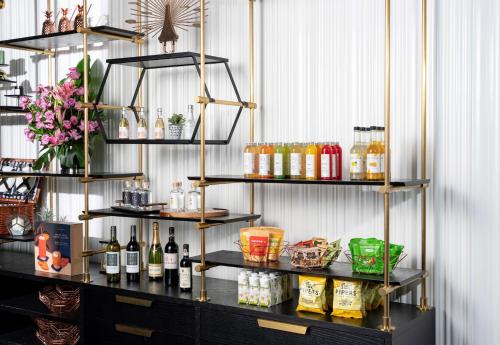 a shelf with bottles of alcohol on it at The Outpost Hotel Sentosa by Far East Hospitality in Singapore