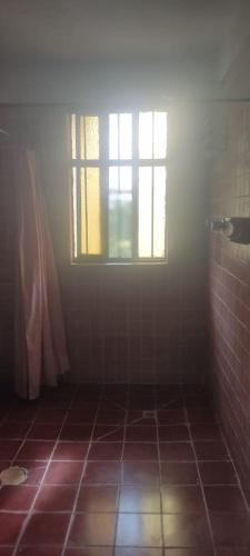 a bathroom with a window and a tiled floor at CASA JUANITA in San Miguel de Allende