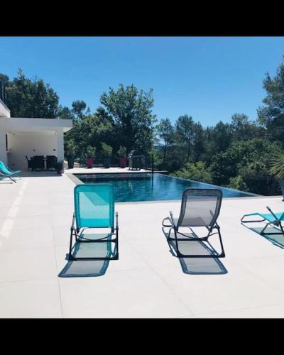3 chaises assises à côté d'une piscine dans l'établissement Petit paradis sur golf, à Flassans-sur-Issole