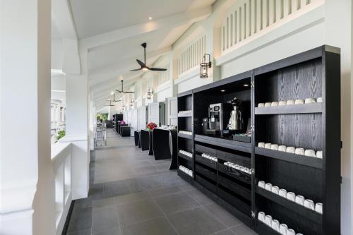 a store with black cabinets and white walls at The Outpost Hotel Sentosa by Far East Hospitality in Singapore