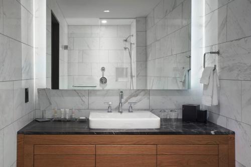 a bathroom with a sink and a mirror at Toronto Marriott Markham in Markham