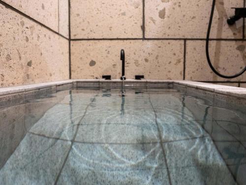 a pool of water with a hose in a room at UU HOME - Vacation STAY 28498v in Biei