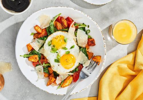 a plate of breakfast salad with eggs and bacon at Courtyard by Marriott Roanoke Airport in Roanoke