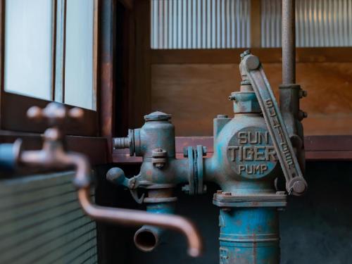a blue fire hydrant sitting in front of a building at Ryokan Kigusuriya in Nantan city