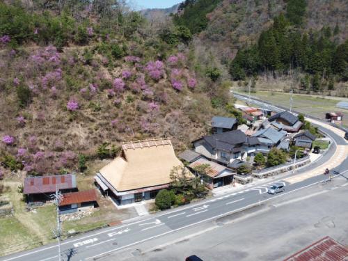 an aerial view of a house with a road and a mountain at Ryokan Kigusuriya in Nantan city