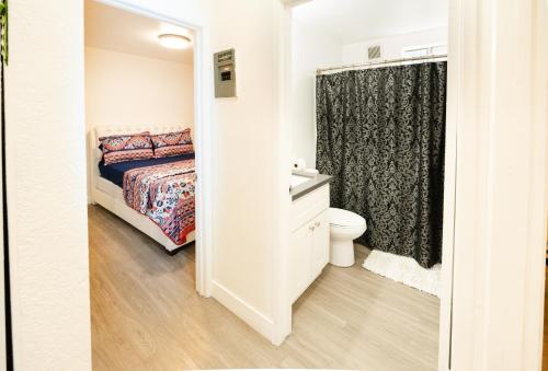 a bedroom with a bed and a toilet and a shower at Cozy Koreatown/Hollywood 2 Bedroom in Los Angeles