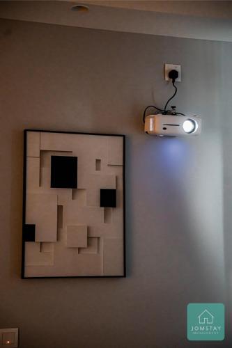 a picture on a wall with a light on it at JOMSTAY Sunway Onsen Suites Ipoh - Lost World of Tambun Ipoh Waterpark in Tambun