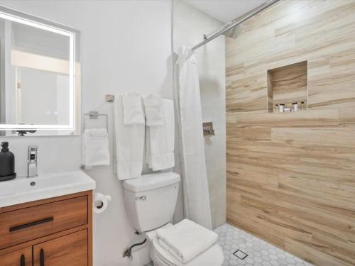 a white bathroom with a toilet and a shower at 43 Terrace Newly Renovated Modern Home in Fort Lauderdale