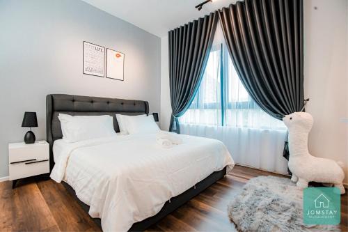 a bedroom with a bed and a large window at JOMSTAY Sunway Onsen Suites Ipoh - Lost World of Tambun Ipoh Waterpark in Tambun