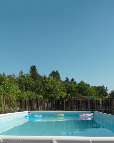 a swimming pool with three frisbees in it at Villa Edemi in Tskaltubo