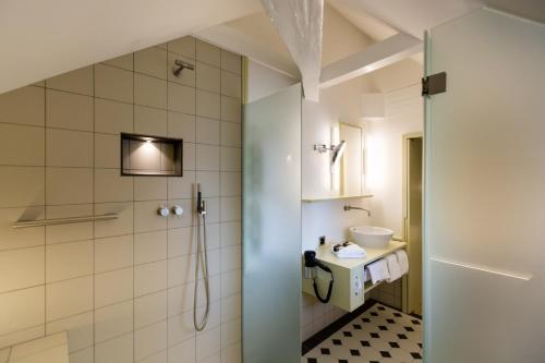 a bathroom with a shower and a sink at Hotel Krone Speicher in Speicher