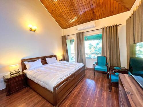 a bedroom with a bed and a television in it at Madnest in Kasauli