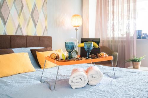 a bed with towels and drinks on a tray on it at Beautiful City Rooms close to Acropolis in Athens