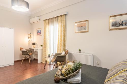 a living room with a bed and a table and chairs at Beautiful City Rooms close to Acropolis in Athens