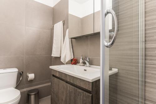 a bathroom with a sink and a toilet at Beautiful City Rooms close to Acropolis in Athens
