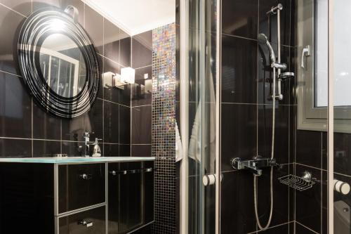 a bathroom with a shower and a mirror at Beautiful City Rooms close to Acropolis in Athens