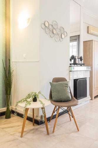 a living room with a chair and a table at Beautiful City Rooms close to Acropolis in Athens