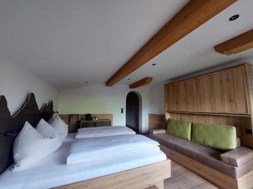 a bedroom with a large bed and a couch at Forellenstube in Lofer
