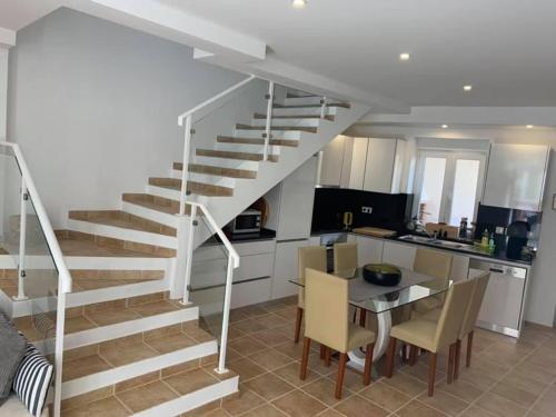 a staircase in a kitchen with a table and chairs at La petite maison in Portimão