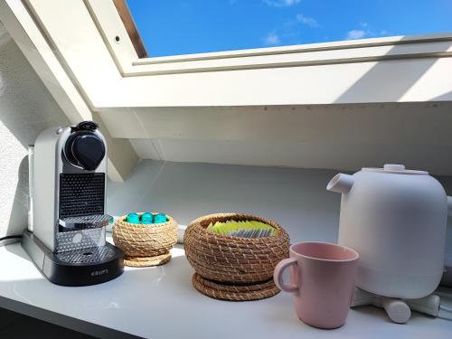 a kitchen counter with baskets and a window at Guesthouse at the Amstel river with 2BR 2BA and garden in Amstelveen