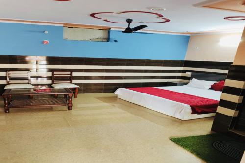 a bedroom with a bed and a blue light at OYO Riverview Resort And Restaurant in Jhājhar