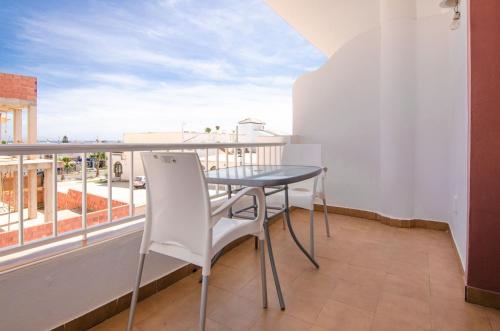 a table and chairs on a balcony with a view at Hostal Manolo in Garrucha