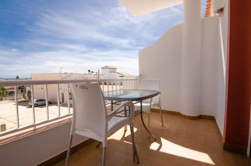 a balcony with a table and a view of a building at Hostal Manolo in Garrucha