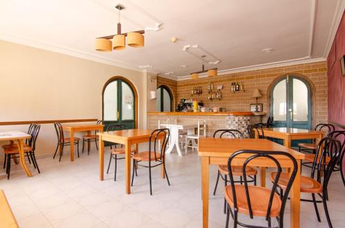 a restaurant with tables and chairs and a bar at Hostal Manolo in Garrucha