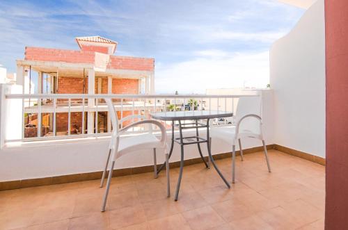 a table and chairs on a balcony with a view at Hostal Manolo in Garrucha