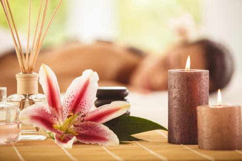 a table with two candles and a flower on it at Radisson Golf Resort Pahalgam in Pahalgām