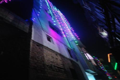 a building with christmas lights on it at night at SPOT ON Pushpanjali Guest House in Patna
