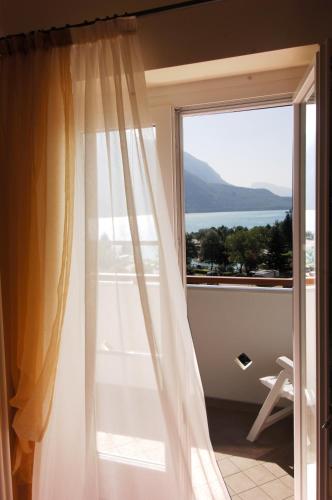 a room with a window with a view of the ocean at Hotel Lido - slow & natural living in Molveno