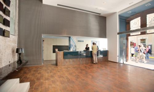 a lobby with people walking around a store at Onix Liceo in Barcelona